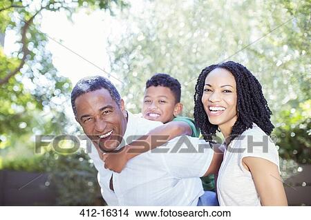 Picture - Portrait of smiling multi-generation family outdoors. Fotosearch