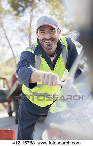 Stock Photo - Portrait of smiling roadside mechanic. Fotosearch