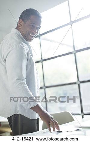 Portrait of smiling senior man at desk View Large Photo Image Stock Image - Portrait of smiling senior man at desk. Fotosearch