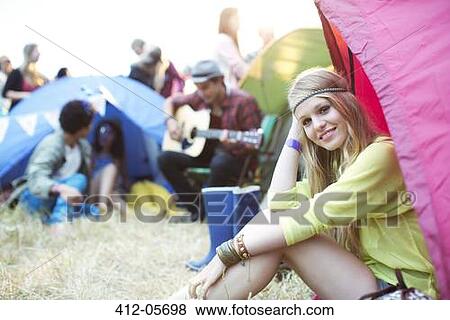 Portrait of smiling woman at tent at music festival View Large Photo Image Stock Photo - Portrait of smiling woman at tent at music festival. Fotosearch