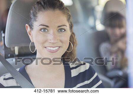 Portrait of smiling woman inside car View Large Photo Image Stock Image - Portrait of smiling woman inside car. Fotosearch