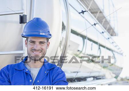 Portrait of smiling worker at back of stainless steel milk tanker View Large Photo Image Stock Image - Portrait of smiling worker at back of stainless steel milk tanker. Fotosearch