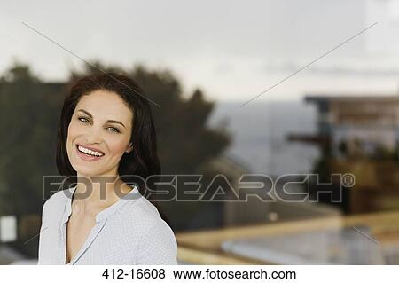 Portrait of woman laughing at window View Large Photo Image Stock Photo - Portrait of woman laughing at window. Fotosearch