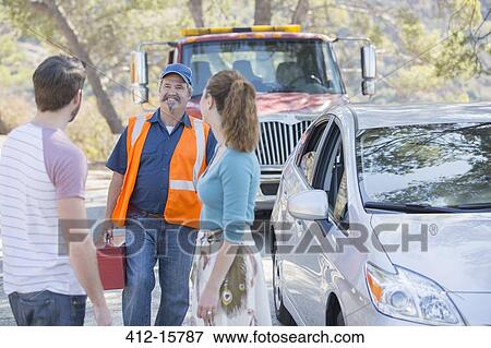 Roadside mechanic arriving to help couple View Large Photo Image Stock Photo - Roadside mechanic arriving to help couple. Fotosearch