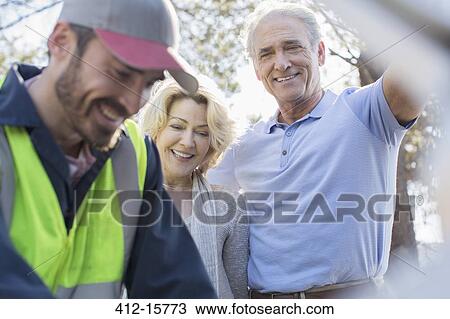 Roadside mechanic helping senior couple View Large Photo Image Stock Image - Roadside mechanic helping senior couple. Fotosearch