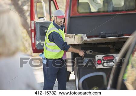 Roadside mechanic preparing to tow car View Large Photo Image Stock Image - Roadside mechanic preparing to tow car. Fotosearch