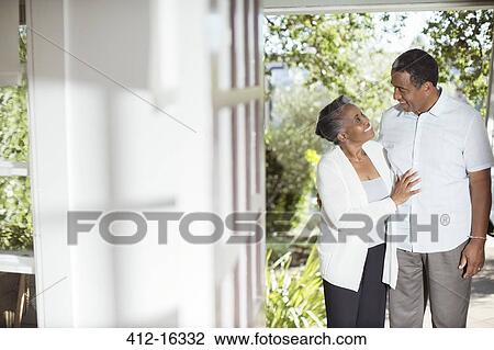 Senior couple hugging on patio View Large Photo Image Stock Image - Senior couple hugging on patio. Fotosearch