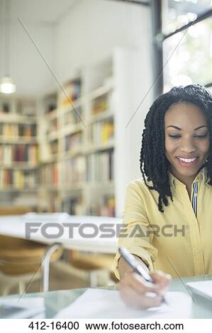 Smiling businesswoman writing on paperwork View Large Photo Image Stock Image - Smiling businesswoman writing on paperwork. Fotosearch