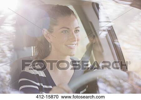 Smiling woman driving car View Large Photo Image Stock Image - Smiling woman driving car. Fotosearch