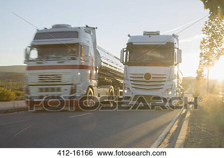 Stainless steel milk tankers on the road side by side View Large Photo Image Stock Photograph - Stainless steel milk tankers on the road side by side. Fotosearch