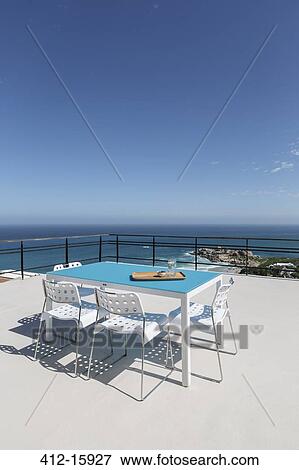Table on patio overlooking ocean View Large Photo Image Stock Photo - Table on patio overlooking ocean. Fotosearch