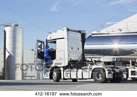Truck driver climbing into stainless steel milk tanker View Large Photo Image Stock Photo - Truck driver climbing into stainless steel milk tanker. Fotosearch