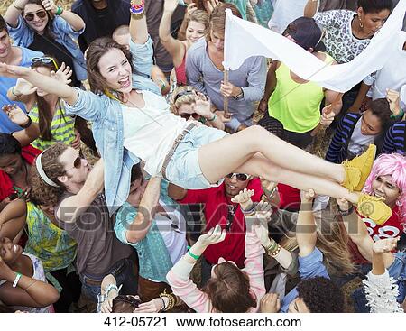 Woman crowd surfing at music festival View Large Photo Image Stock Image - Woman crowd surfing at music festival. Fotosearch