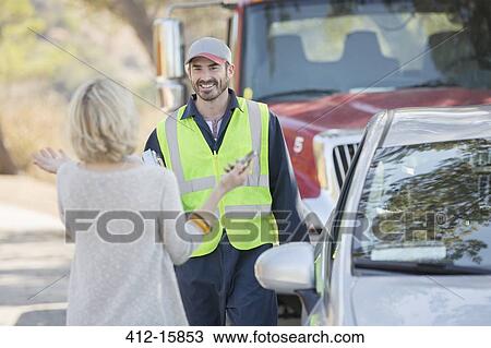 Woman greeting roadside mechanic View Large Photo Image Stock Image - Woman greeting roadside mechanic. Fotosearch