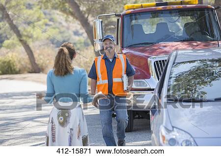 Woman greeting roadside mechanic View Large Photo Image Stock Image - Woman greeting roadside mechanic. Fotosearch