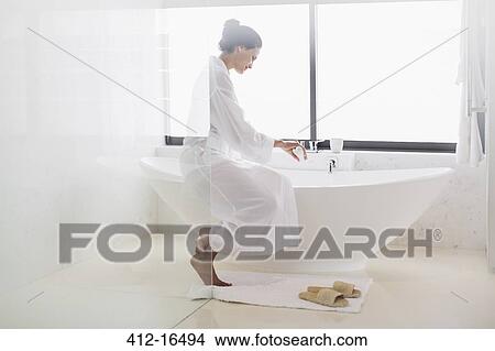 Woman in bathrobe preparing bath View Large Photo Image Picture - Woman in bathrobe preparing bath. Fotosearch
