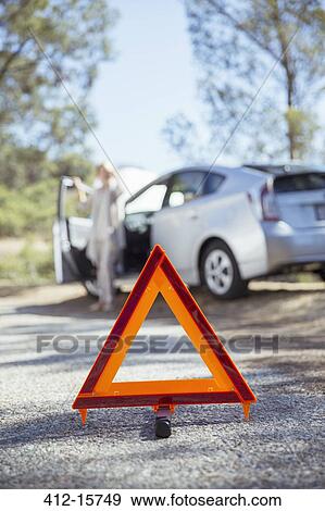 Woman talking on cell phone with automobile hood raised at roadside View Large Photo Image Stock Photo - Woman talking on cell phone with automobile hood raised at roadside. Fotosearch