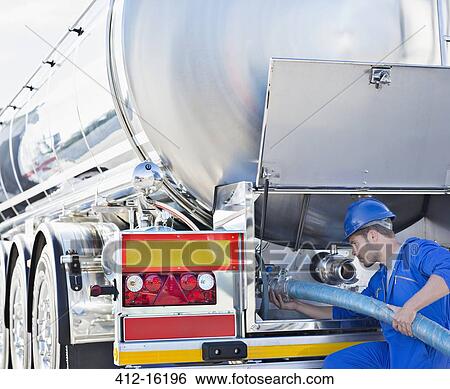 Worker attaching hose to back of stainless steel milk tanker View Large Photo Image Stock Photograph - Worker attaching hose to back of stainless steel milk tanker. Fotosearch