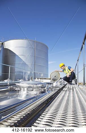 Worker on platform above stainless steel milk tanker View Large Photo Image Stock Image - Worker on platform above stainless steel milk tanker. Fotosearch