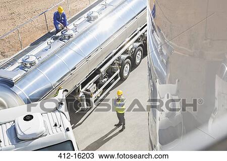 Workers around stainless steel milk tanker View Large Photo Image Stock Image - Workers around stainless steel milk tanker. Fotosearch
