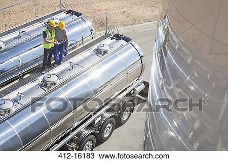 Workers on platform above stainless steel milk tanker View Large Photo Image Stock Image - Workers on platform above stainless steel milk tanker. Fotosearch