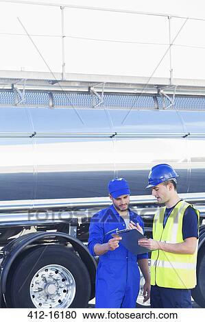 Workers with clipboard talking next to stainless steel milk tanker View Large Photo Image Stock Image - Workers with clipboard talking next to stainless steel milk tanker. Fotosearch