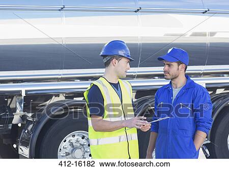 Workers with clipboard talking next to stainless steel milk tanker View Large Photo Image Stock Image - Workers with clipboard talking next to stainless steel milk tanker. Fotosearch