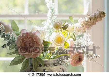 Stock Photography - Beautiful bouquet in sunny window. Fotosearch