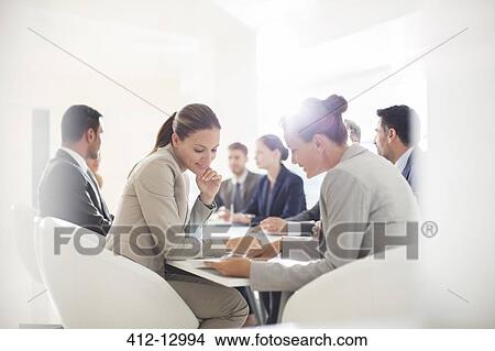 Picture - Business people meeting at conference table. Fotosearch