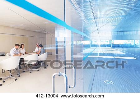 Picture - Business people meeting at conference table. Fotosearch