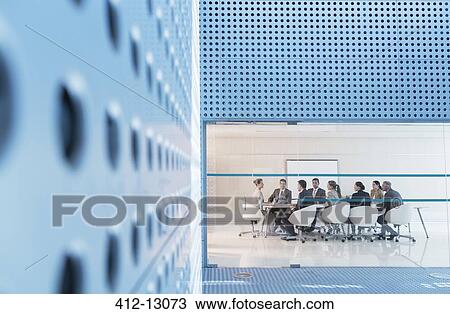Stock Image - Business people meeting at conference room table. Fotosearch