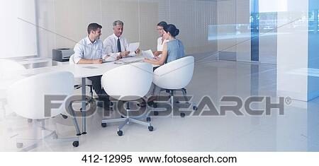 Stock Photography - Business people meeting at conference table. Fotosearch