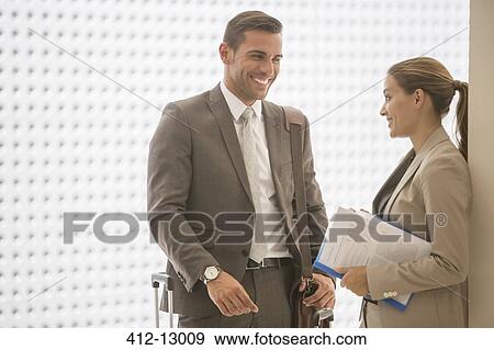 Business people talking in corridor View Large Photo Image Stock Photo - Business people talking in corridor. Fotosearch