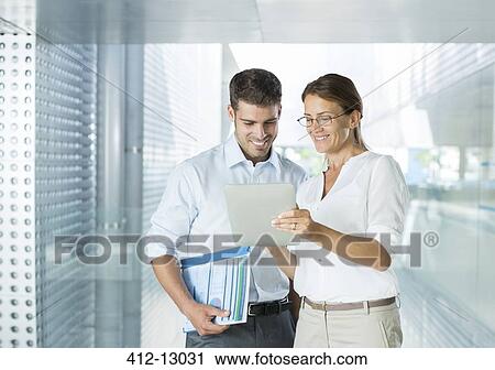 Business people using digital tablet in office View Large Photo Image Stock Image - Business people using digital tablet in office. Fotosearch