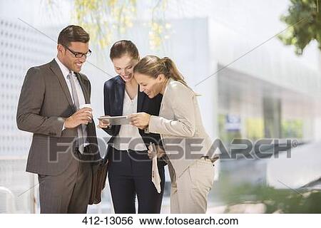 Business people using digital tablet outdoors View Large Photo Image Stock Photograph - Business people using digital tablet outdoors. Fotosearch