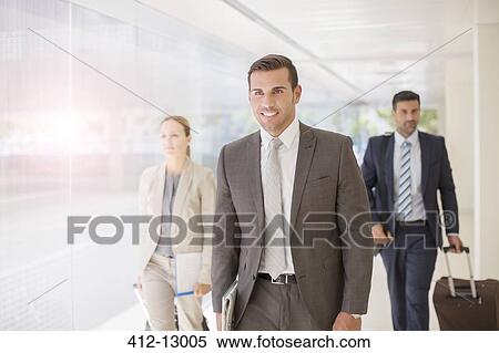 Stock Photography - Business people walking in corridor. Fotosearch
