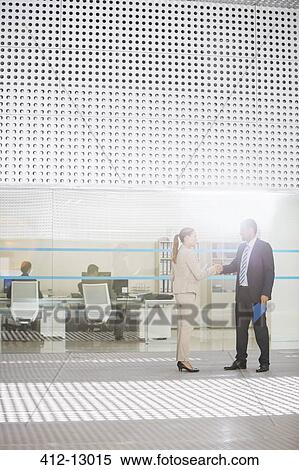 Businessman and businesswoman handshaking outside office View Large Photo Image Stock Photography - Businessman and businesswoman handshaking outside office. Fotosearch