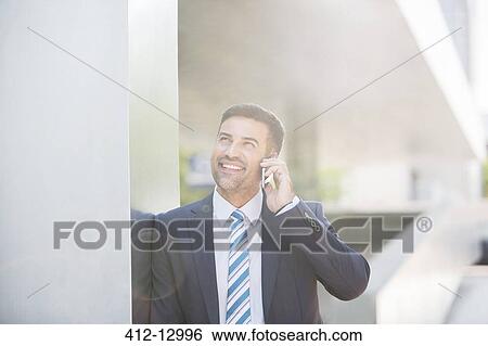 Businessman talking on cell phone View Large Photo Image Stock Photograph - Businessman talking on cell phone. Fotosearch