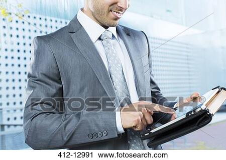 Businessman using digital tablet View Large Photo Image Stock Image - Businessman using digital tablet. Fotosearch