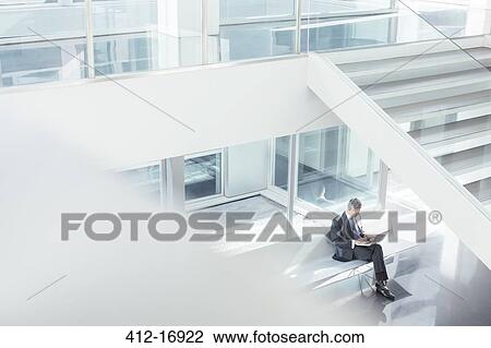Stock Image - Businessman using laptop in modern office. Fotosearch