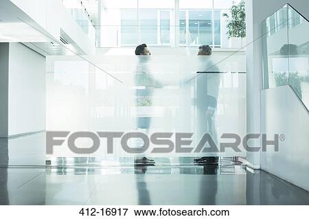 Businessmen talking in modern office View Large Photo Image Stock Photo - Businessmen talking in modern office. Fotosearch