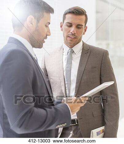 Businessmen using digital tablet View Large Photo Image Stock Image - Businessmen using digital tablet. Fotosearch
