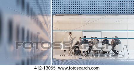 Businesswoman leading meeting in modern conference room View Large Photo Image Stock Photography - Businesswoman leading meeting in modern conference room. Fotosearch