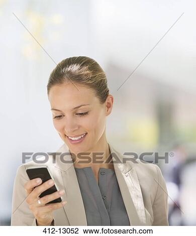 Businesswoman texting with cell phone outdoors View Large Photo Image Stock Image - Businesswoman texting with cell phone outdoors. Fotosearch