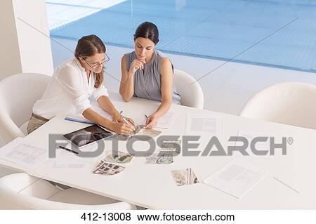 Stock Photo - Businesswomen meeting at conference table. Fotosearch