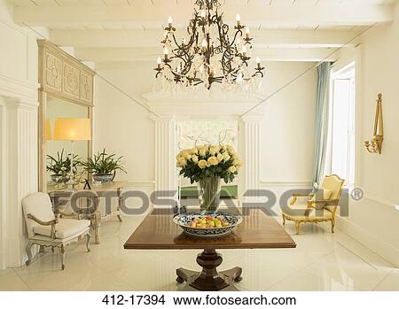 Chandelier over rose bouquet on table in luxury foyer View Large Photo Image Picture - Chandelier over rose bouquet on table in luxury foyer. Fotosearch