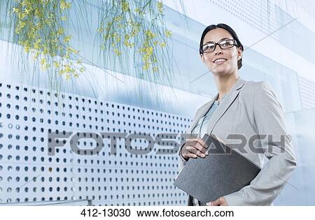Stock Image - Confident businesswoman outdoors. Fotosearch
