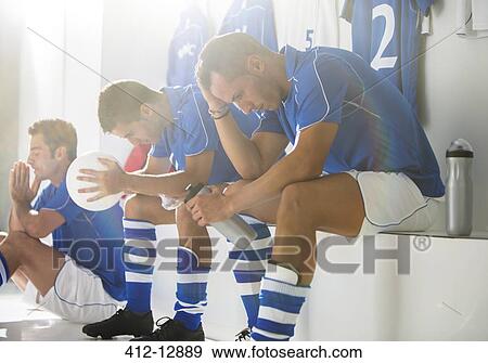 Disappointed soccer players sitting in locker room View Large Photo Image Stock Photo - Disappointed soccer players sitting in locker room. Fotosearch