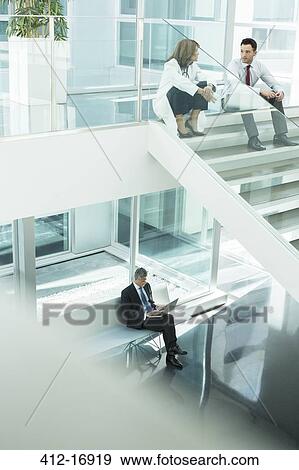 Stock Photo - Doctor and administrator talking on hospital stairs. Fotosearch