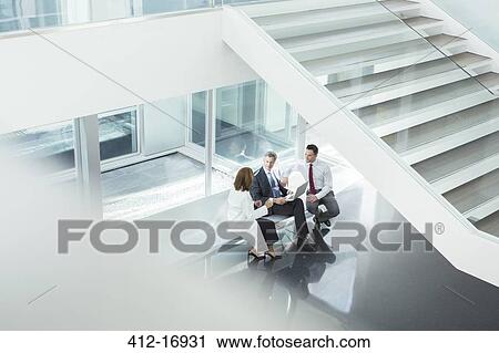 Doctor and administrators talking in hospital lobby View Large Photo Image Stock Image - Doctor and administrators talking in hospital lobby. Fotosearch
